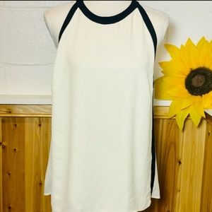 A beautiful flowy tank/cami in white with black trim with zip. New condition.